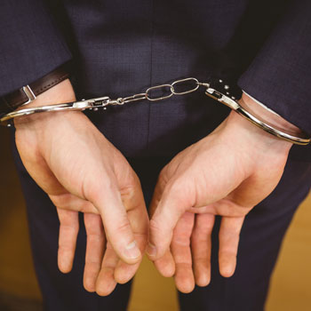 Business man in court in handcuffs