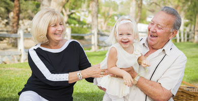 Grandparents playing with their granddaughter