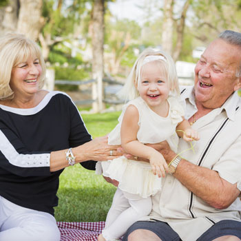 Grandparents playing with their granddaughter